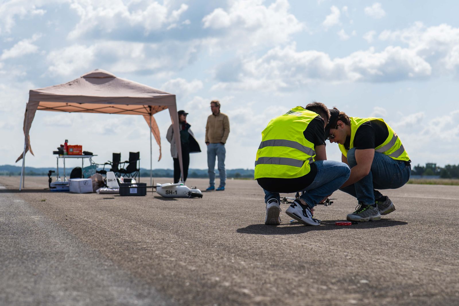 Pilots in hi-vis preparing an airframe on the runway